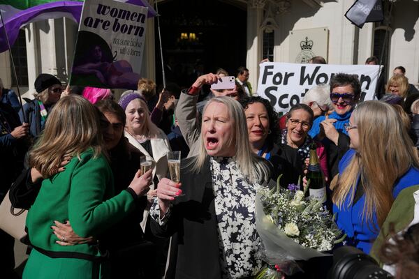 Marion Calder and Susan Smith from For Women Scotland, celebrate outside the Supreme Court to challenge gender recognition laws, in London, Wednesday, April 16, 2025. (AP Photo/Kin Cheung)