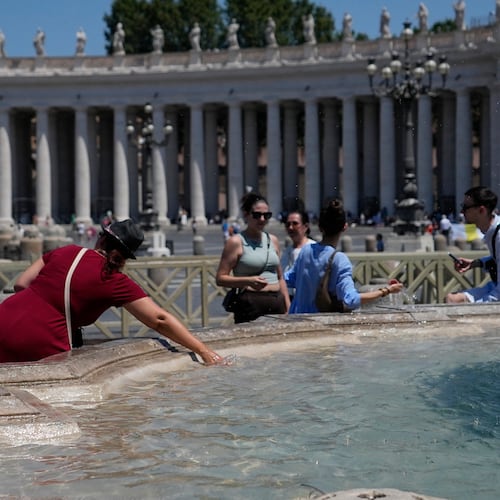 People refresh in a fountain after the Angelus noon prayer celebrated by Pope Leo XIV from the window of his studio overlooking St.Peter's Square, at the Vatican, Sunday, June 28, 2026. (AP Photo/Alessandra Tarantino)