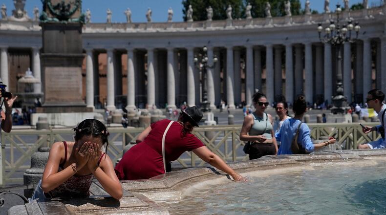 People refresh in a fountain after the Angelus noon prayer celebrated by Pope Leo XIV from the window of his studio overlooking St.Peter's Square, at the Vatican, Sunday, June 28, 2026. (AP Photo/Alessandra Tarantino)