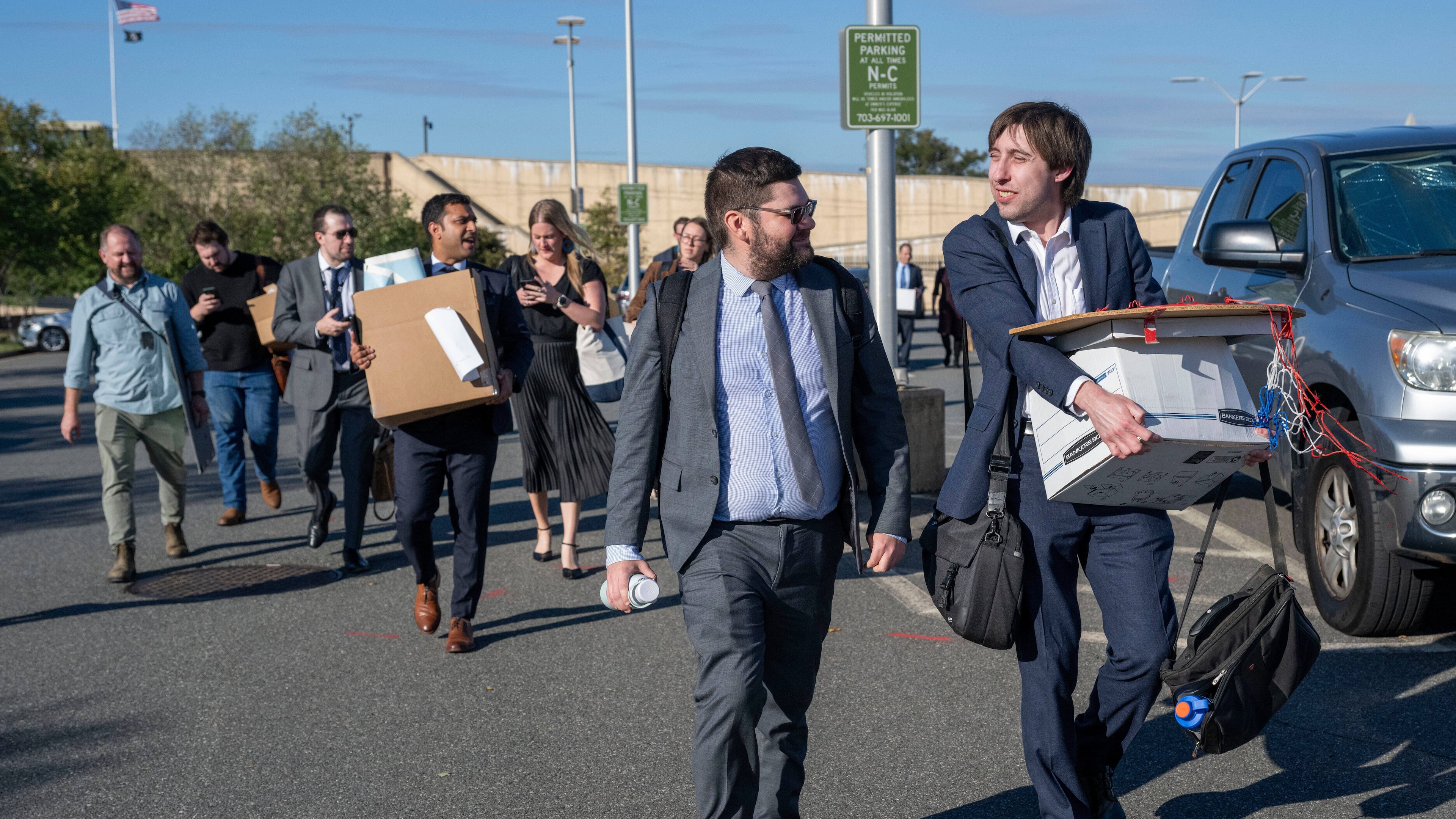 Members of the Pentagon press corp carry their belongings out of the Pentagon after turning in their press credentials, Wednesday, Oct. 15, 2025 in Washington. (AP Photo/Kevin Wolf)