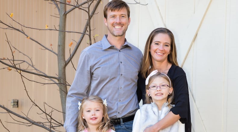 Patrick and Madelyn Gahan of west Cobb, with their daughters, Mya and Anya. Mya (the smaller girl) had a heart transplant at the age of 3. She is now 7 and doing well. (Lindsay Larson / Special)