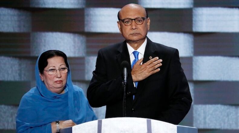 FILE - In this Thursday, July 28, 2016 file photo, Khizr Khan, father of fallen US Army Capt. Humayun S. M. Khan and his wife Ghazala speak during the final day of the Democratic National Convention in Philadelphia. Republican presidential nominee Donald Trump broke a major American political and societal taboo over the weekend when he engaged in an emotionally-charged feud with Khizr and Ghazala Khan, the bereaved parents of a decorated Muslim Army captain killed by a suicide bomber in Iraq. He further stoked outrage by implying Ghazala Khan did not speak while standing alongside her husband at last week's Democratic convention because they are Muslim. (AP Photo/J. Scott Applewhite, File)