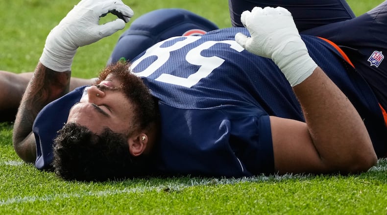 Chicago Bears offensive line Darnell Wright warms up during practice at the team's NFL football training camp, Friday, July 31, 2026, in Lake Forest, Ill. (AP Photo/Nam Y. Huh)