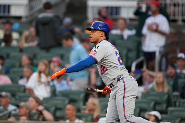 New York Mets' Juan Soto (22) watches his solo home run in the first inning of a baseball game against the Atlanta Braves, Tuesday, June 17, 2025, in Atlanta. (AP Photo/Brynn Anderson)