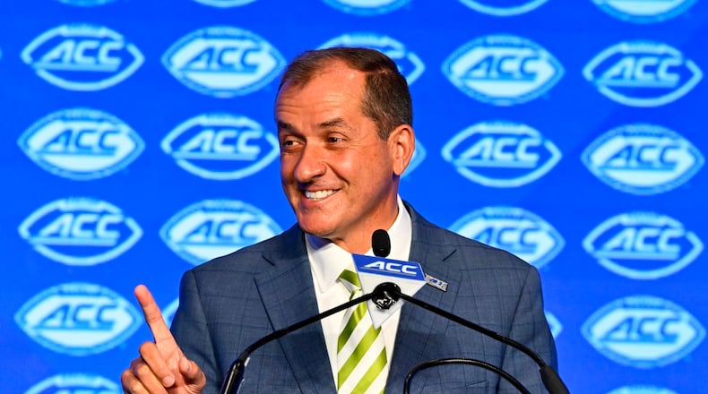 FILE - Atlantic Coast Conference commissioner Jim Phillips smiles during an NCAA college football news conference at the ACC media days, July 22, 2024, in Charlotte, N.C. (AP Photo/Matt Kelley, File)