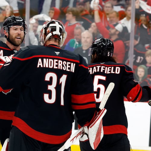 Carolina Hurricanes goaltender Frederik Andersen (31) is congratulated by Jaccob Slavin, left, following Game 1 of an NHL hockey Stanley Cup second-round playoff series against the Philadelphia Flyers in Raleigh, N.C., Saturday, May 2, 2026. (AP Photo/Karl DeBlaker)