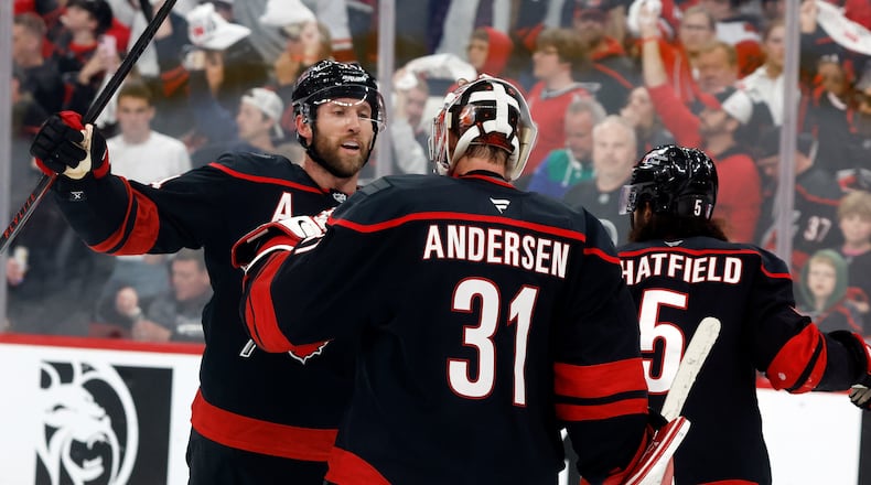 Carolina Hurricanes goaltender Frederik Andersen (31) is congratulated by Jaccob Slavin, left, following Game 1 of an NHL hockey Stanley Cup second-round playoff series against the Philadelphia Flyers in Raleigh, N.C., Saturday, May 2, 2026. (AP Photo/Karl DeBlaker)