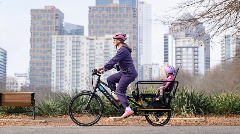 A mother and daughter ride an e-bike through Piedmont park on Wednesday, Jan 7, 2026 (Ben Hendren for the AJC)