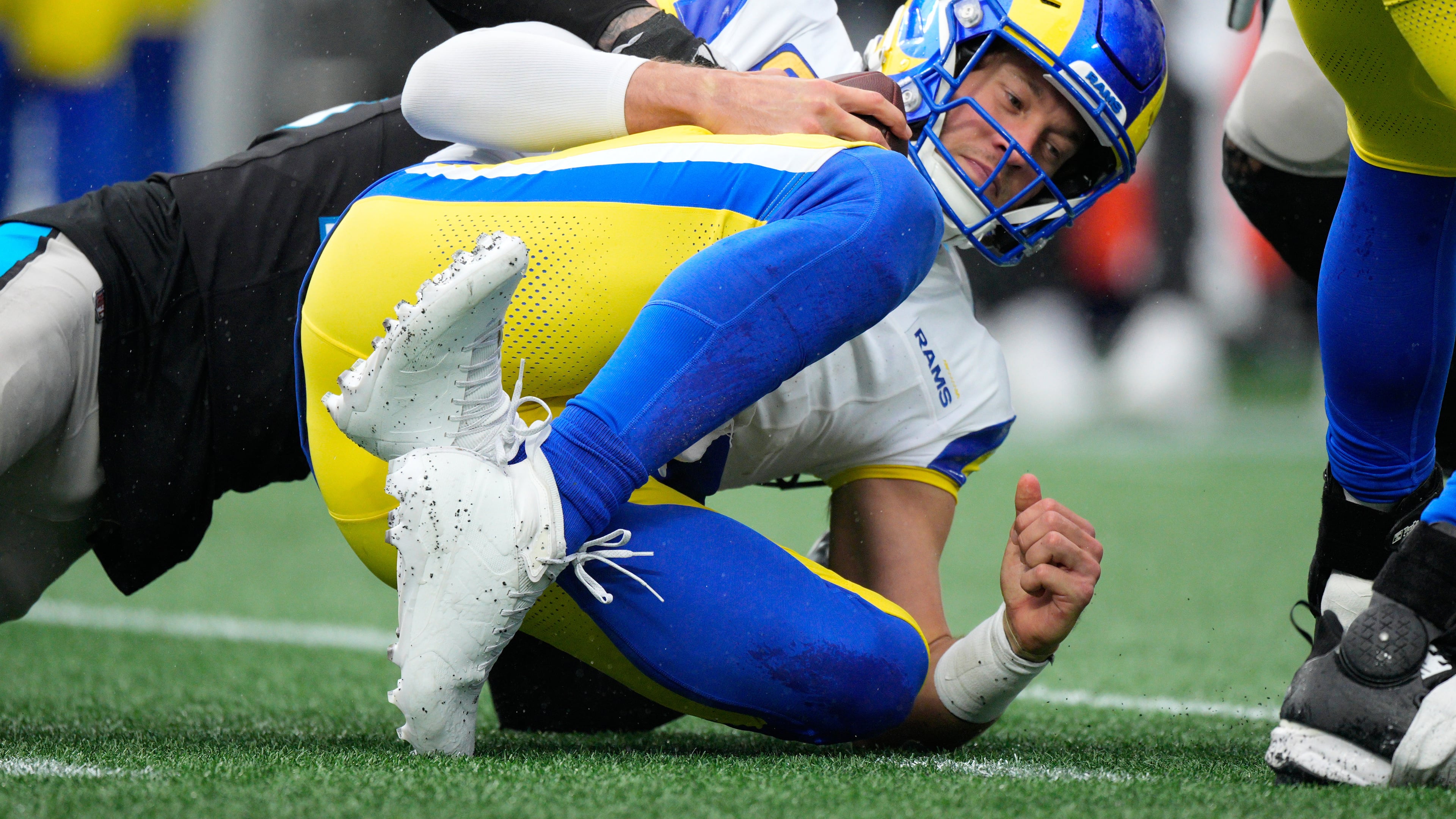 Los Angeles Rams quarterback Matthew Stafford is sacked by Carolina Panthers safety Lathan Ransom during the second half of an NFL football game, Sunday, Nov. 30, 2025, in Charlotte, N.C. (AP Photo/Jacob Kupferman)