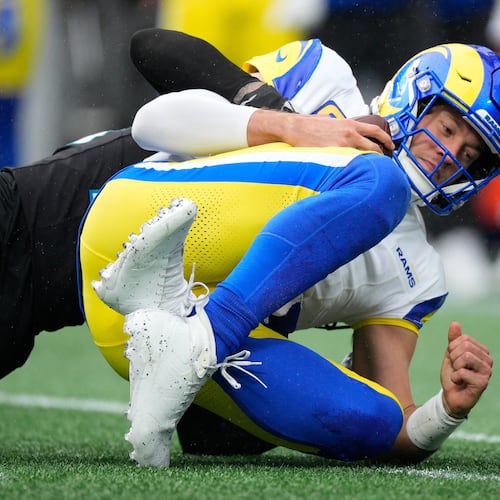Los Angeles Rams quarterback Matthew Stafford is sacked by Carolina Panthers safety Lathan Ransom during the second half of an NFL football game, Sunday, Nov. 30, 2025, in Charlotte, N.C. (AP Photo/Jacob Kupferman)