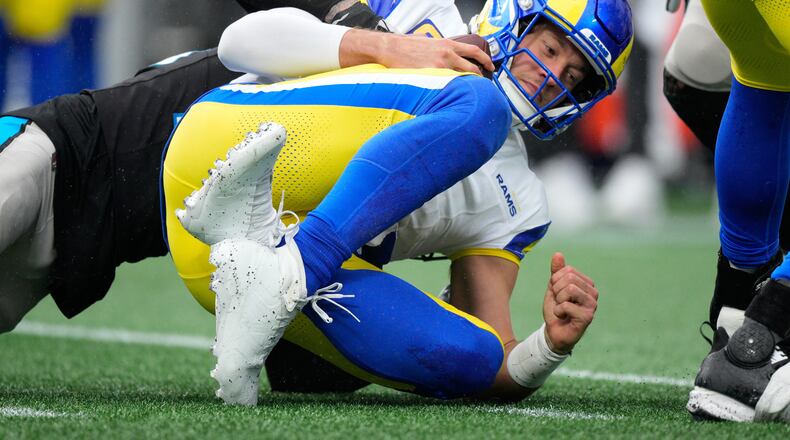 Los Angeles Rams quarterback Matthew Stafford is sacked by Carolina Panthers safety Lathan Ransom during the second half of an NFL football game, Sunday, Nov. 30, 2025, in Charlotte, N.C. (AP Photo/Jacob Kupferman)