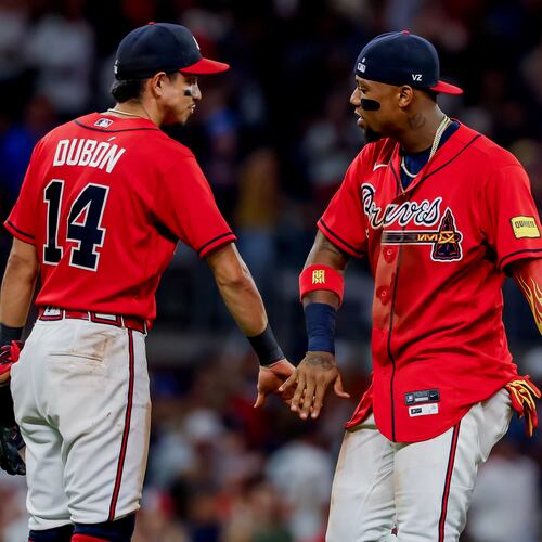 Atlanta Braves' Ronald Acuña Jr., right, celebrates with Mauricio Dubón (14) after their team defeated the Colorado Rockies in a baseball game, Friday, Aug. 28, 2026, in Atlanta. (AP Photo/Erik S. Lesser)