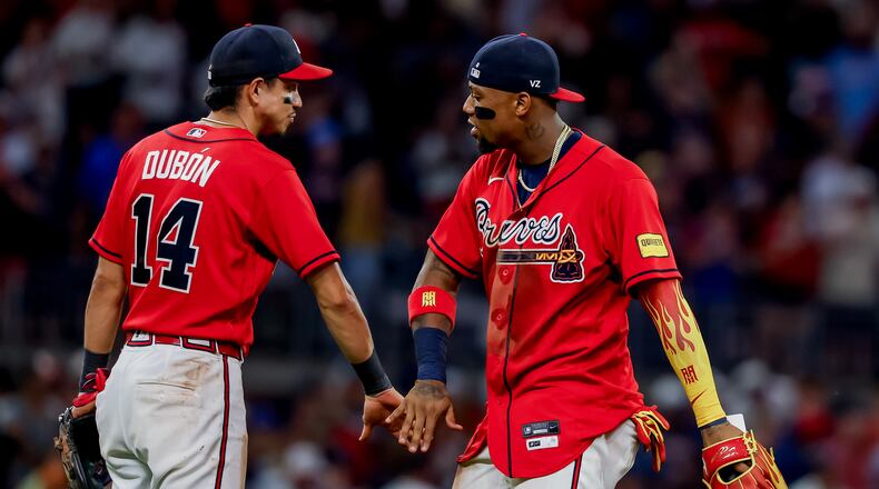 Atlanta Braves' Ronald Acuña Jr., right, celebrates with Mauricio Dubón (14) after their team defeated the Colorado Rockies in a baseball game, Friday, Aug. 28, 2026, in Atlanta. (AP Photo/Erik S. Lesser)