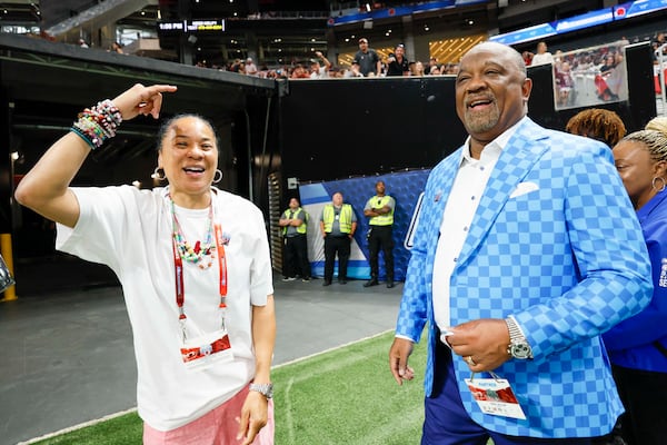 Aflac President Virgil Miller and the South Carolina Gamecocks women's basketball coach Dawn Staley are recognized moments before the Aflac Kickoff Game between South Carolina and Virginia Tech at Mercedes-Benz Stadium on Sunday, Aug. 31, 2025, in Atlanta. (Miguel Martinez/AJC)