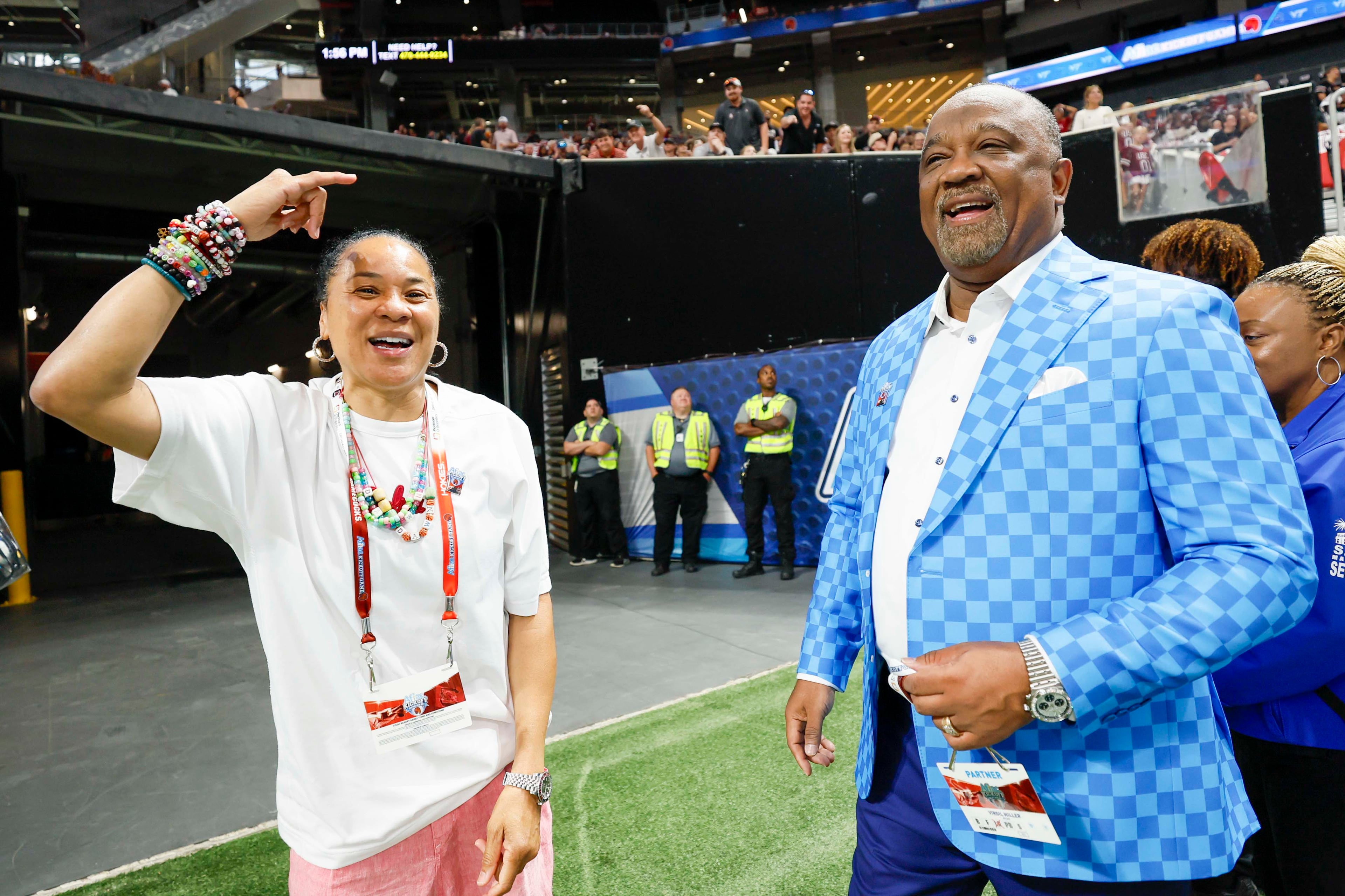 Aflac President Virgil Miller and the South Carolina Gamecocks women's basketball coach Dawn Staley are recognized moments before the Aflac Kickoff Game between South Carolina and Virginia Tech at Mercedes-Benz Stadium on Sunday, Aug. 31, 2025, in Atlanta. (Miguel Martinez/AJC)