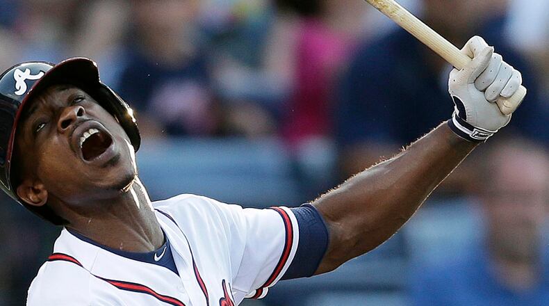 Braves' B.J. Upton reacts as he strikes out in the third inning against the New York Mets, Thursday, June 20, 2013, in Atlanta. (AP Photo/John Bazemore)