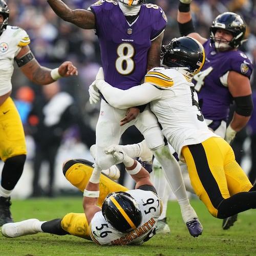 Pittsburgh Steelers linebacker Alex Highsmith (56) and linebacker Nick Herbig (51) tackle Baltimore Ravens quarterback Lamar Jackson (8) during the second half of an NFL football game, Sunday, Dec. 7, 2025, in Baltimore. (AP Photo/Stephanie Scarbrough)