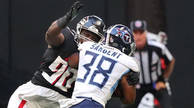 Falcons defensive lineman Marlon Davidson tackles Tennessee Titans running back Mekhi Sargent during the first half of exhibition game Friday, Aug. 13, 2021, in Atlanta. (Curtis Compton / Curtis.Compton@ajc.com)