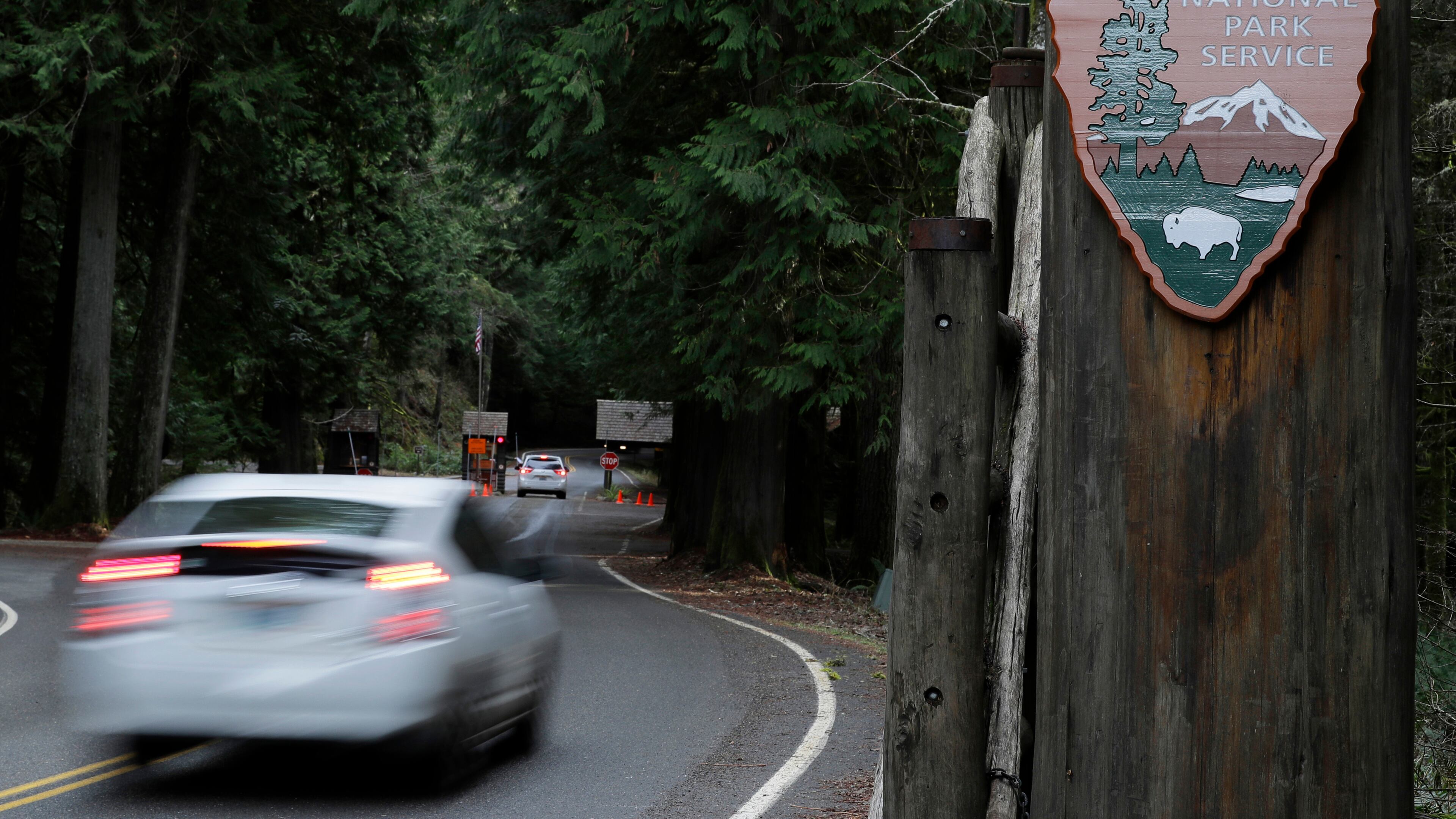 FILE - A car drives past the Nisqually entrance to Mount Rainier National Park on Jan. 28, 2019, in Washington state. (AP Photo/Ted S. Warren, File)