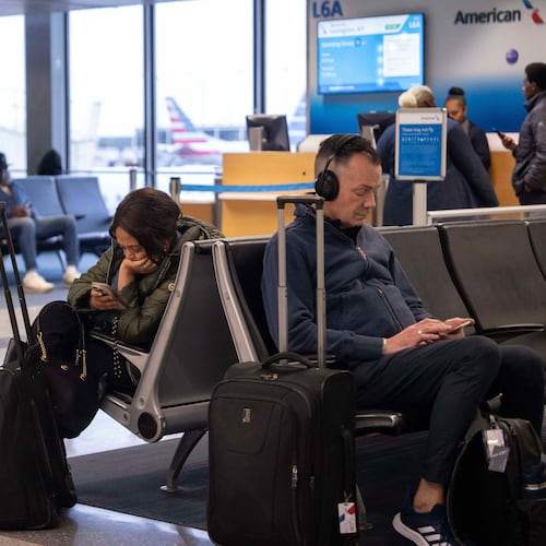 People wait for flights at Chicago O'Hare International Airport in Chicago, Ill., Sunday, Nov. 9, 2025. (AP Photo/Adam Gray)