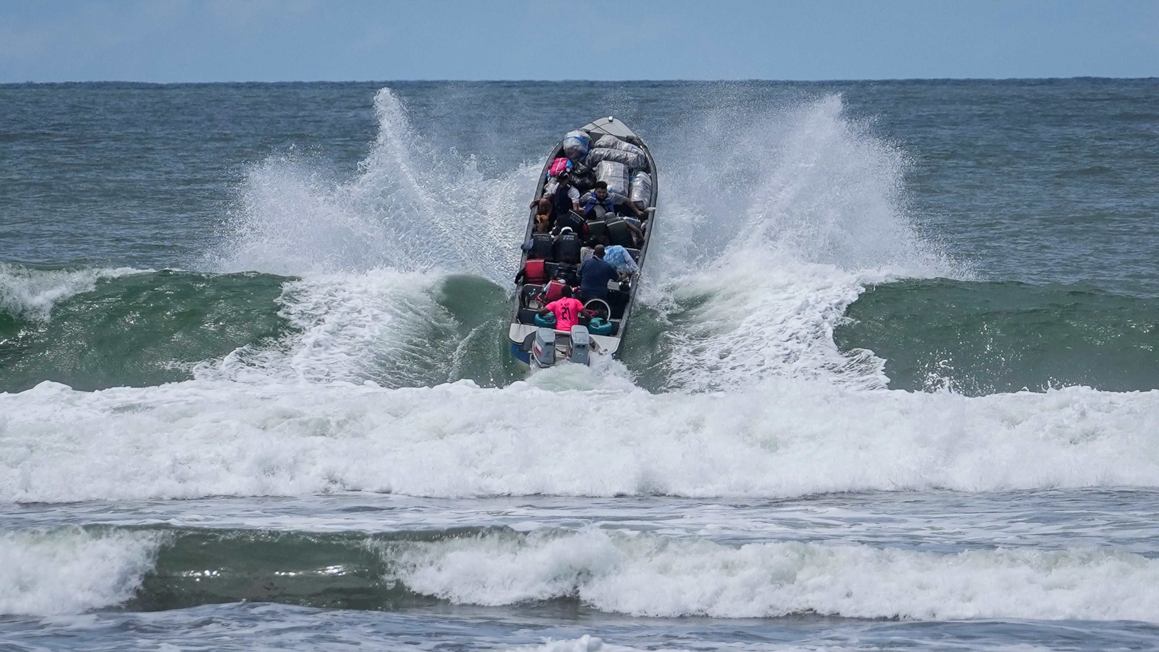 Venezuelan migrants depart Jaque on Panama's Pacific coast en route to Jurado, Colombia, as they return home after failing to enter the United States, Friday, Sept. 19, 2025. (AP Photo/Matias Delacroix)