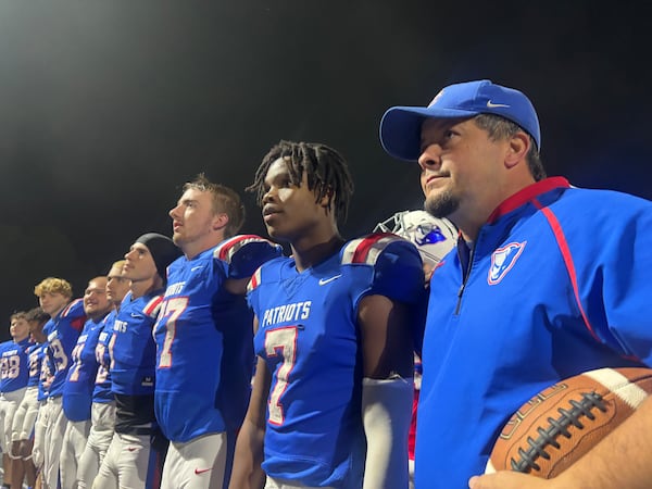 Oglethorpe County football coach Mike Holland stands with his football team after a playoff-clinching win over Providence Christian on Friday, Oct. 24, 2025. “When you get a little bit of that hope, a little bit of that belief, you can start playing up to your potential,” Holland says. (Jack Leo/AJC)