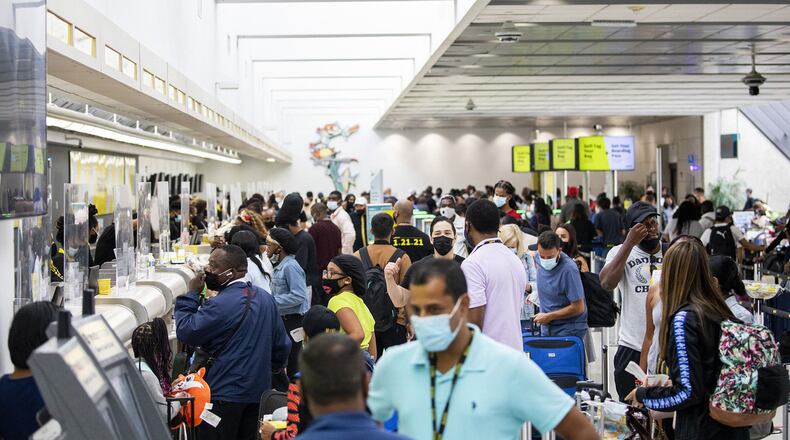 Passengers check in and wait by the Spirit Airlines ticket counter in Terminal 4 at Fort Lauderdale-Hollywood International Airport. (Chris Day/Sun Sentinel/TNS)