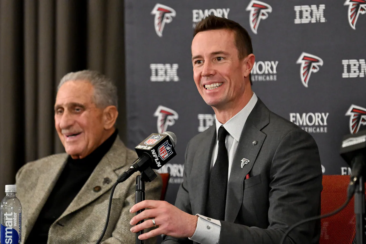 New Atlanta Falcons president of football Matt Ryan speaks as Falcons owner Arthur M. Blank (left) reacts during an introductory news conference Jan. 13, 2026, in Flowery Branch. It is now thought Ryan could be leaning toward James Liipfert as the team's new general manager. (Hyosub Shin/AJC)