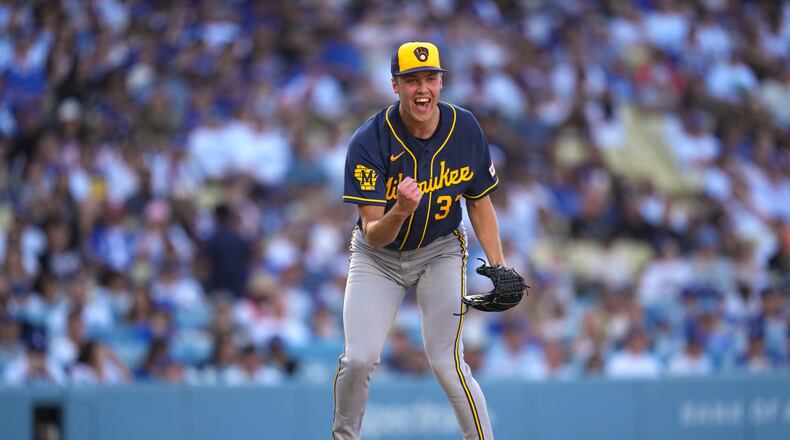 Milwaukee Brewers starting pitcher Jacob Misiorowski, left, celebrates after striking out Los Angeles Dodgers' Tommy Edman during the sixth inning of a baseball game Saturday, Aug. 15, 2026, in Los Angeles. (AP Photo/Mark J. Terrill)