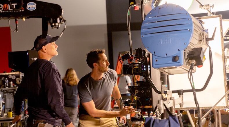 First assistant camera Clint Moran (right) preps a camera for a commercial shoot on a sound stage at PC&E motion equipment rental service in Atlanta on Thursday, November 9, 2023. PC&E expects rentals to rise as the SAG-AFTRA actors strike ends. (Arvin Temkar / arvin.temkar@ajc.com)