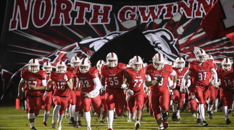 It's playoff time: North Gwinnett players run onto the field before a 51-14 win over Shiloh in the Class AAAAAAA playoffs. (Jason Getz/Special)
