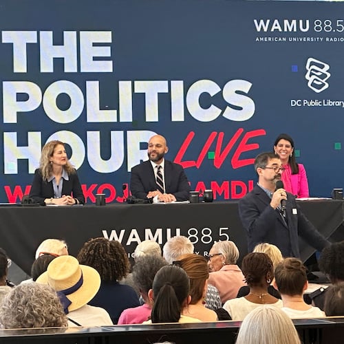 Robert White Jr., center, and Brooke Pinto, right, candidates for Washington D.C. delegate, participate in a forum at the Martin Luther King Jr. Memorial Library, Friday, May 29, 2026. (AP Photo/Gary Fields)