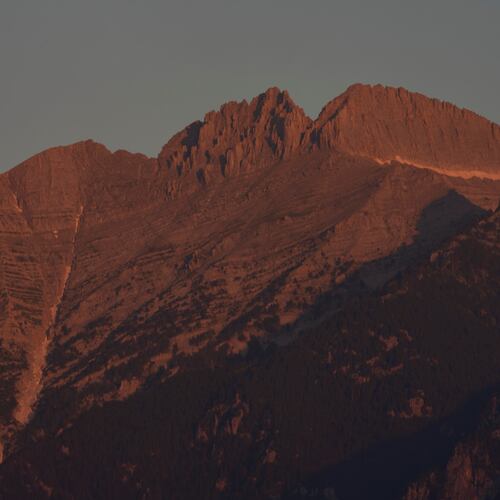 The morning light shines on Mytikas, Greece's highest peak, center left, and Stefani, known as the Throne of Zeus, center right, atop Mount Olympus seen from the outskirts of Litochoro in northern Greece, Wednesday, July 15, 2026. (AP Photo/Petros Giannakouris)