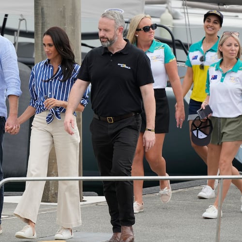 FILE - Prince Harry, left, and his wife Meghan, the Duke and Duchess of Sussex, arrive at a dock after sailing on the harbor in Sydney, Friday, April 17, 2026. (AP Photo/Rick Rycroft, File)