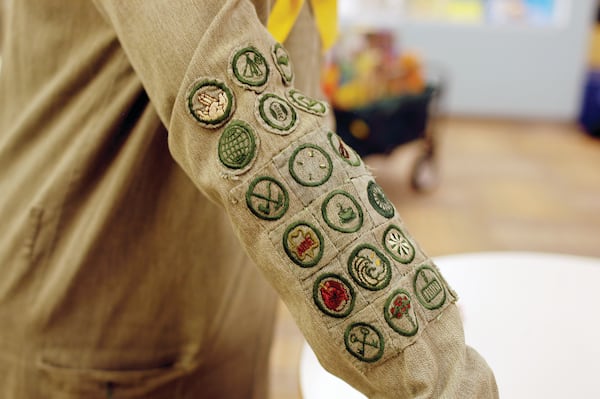 Girl Scout archivist Sue Belden displays old scouting badges. (Source: Donna P. Williams)