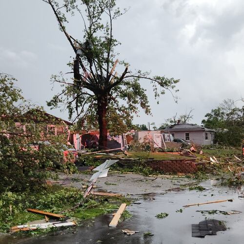 First responders walk through debris on Thursday, June 11, 2026 after a tornado passed through Merrillville, Ind. (Michael Sneiderwine via AP)