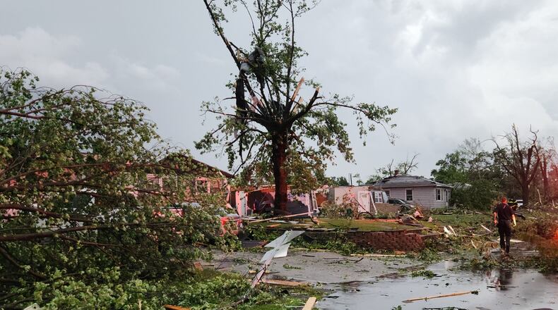 First responders walk through debris on Thursday, June 11, 2026 after a tornado passed through Merrillville, Ind. (Michael Sneiderwine via AP)