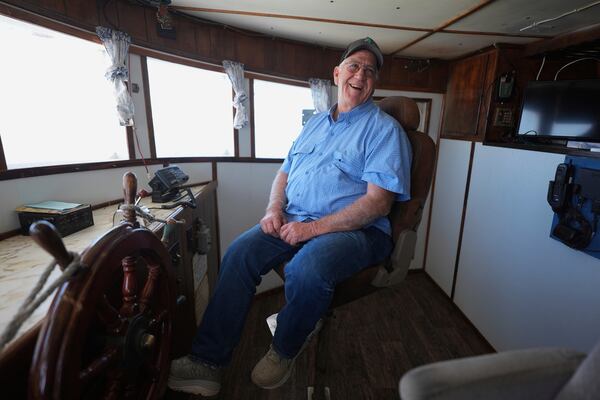 Craig Wallis, owner of W&W Dock and Ice sits in the captain's seat of one of his docked shrimp boats, Wednesday, April 9, 2025, in Palacios, Texas. (AP Photo/Eric Gay)