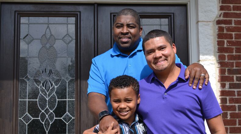 Chris Inniss (right), Shelton Stroman and son Jonathan pose for a photo in front of their home in Snellville on Aug. 7, 2015. The couple has been together for 14 years. DANIEL FUNKE / DANIEL.FUNKE@COXINC.COM