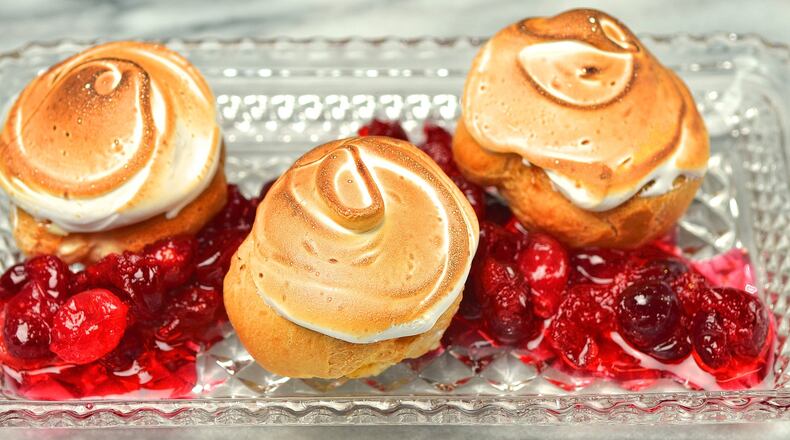 Eggnog Cream Puffs with Eggnog Pastry Cream and orange-scented cranberries. (Chris Hunt/Special)