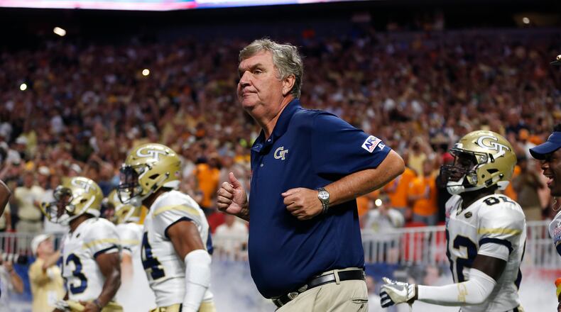 Georgia Tech head coach Paul Johnson runs onto the field with his players before in the first half of an NCAA college football game against the Tennessee Monday, Sept. 4, 2017, in Atlanta. (AP Photo/John Bazemore)