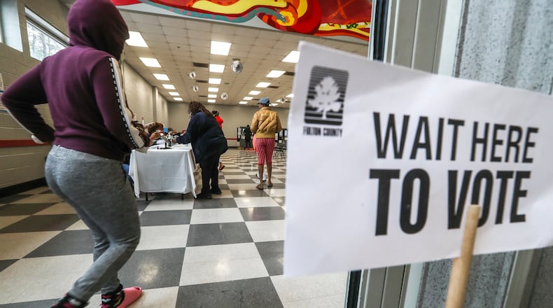 Voters enter on Tuesday, Dec. 6, 2022 at the C.T. Martin Natatorium and Recreation Center located at 3201 M.L.K. Jr Drive SW in Atlanta. (John Spink / John.Spink@ajc.com)