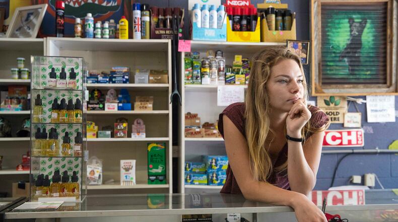 06/06/2018 --Blue Ridge, GA -- Brittany Abt listens to a conversation at Caterpillars Tobacco Accessories and Gifts in Blue Ridge, Wednesday, June 6, 2018. In April of 2017, Caterpillars Tobacco Accessories and Gifts was raided and the owner, Brittany's mother, Judena Beardmore, was charged with possession of marijuana for resale, in addition to other crimes. She was recently sentenced to 10 years in prison for selling small amounts of marijuana. Brittany works at the store during her summer break from studying at the University of Georgia.   ALYSSA POINTER/ATLANTA JOURNAL-CONSTITUTION