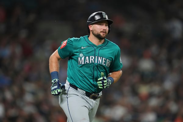 Seattle Mariners' Cal Raleigh rounds first base after hitting a grand slam against the Detroit Tigers in the ninth inning during a baseball game, Friday, July 11, 2025, in Detroit. (AP Photo/Paul Sancya)