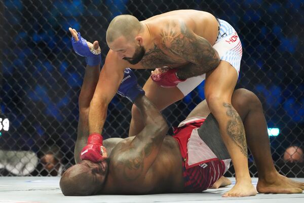 Josh Hokit lands a punch as he fights Derrick Lewis during their heavyweight bout at UFC Freedom 250 on the South Lawn of the White House on Sunday, June 14, 2026, in Washington. (Alex Brandon/AP)