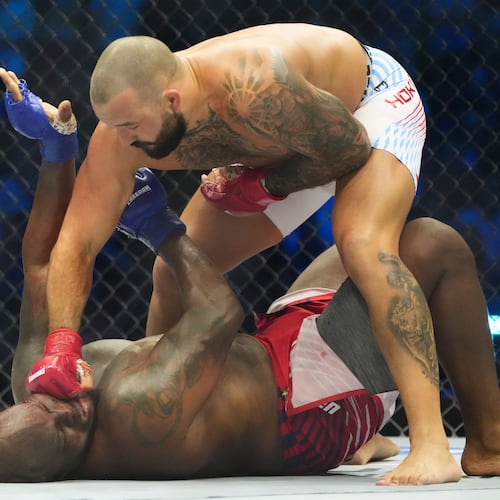 Josh Hokit lands a punch as he fights Derrick Lewis during their heavyweight bout at UFC Freedom 250 on the South Lawn of the White House, Sunday, June 14, 2026, in Washington. (AP Photo/Alex Brandon)