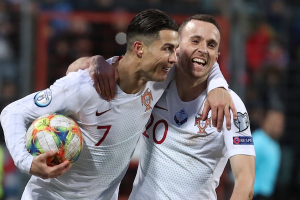 FILE - Portugal's Cristiano Ronaldo, left, celebrates with his teammate Diogo Jota after he scored his side's second goal during the Euro 2020 group B qualifying soccer match between Luxembourg and Portugal at the Josy Barthel stadium in Luxembourg, Sunday, Nov. 17, 2019. (AP Photo/Francisco Seco, File)