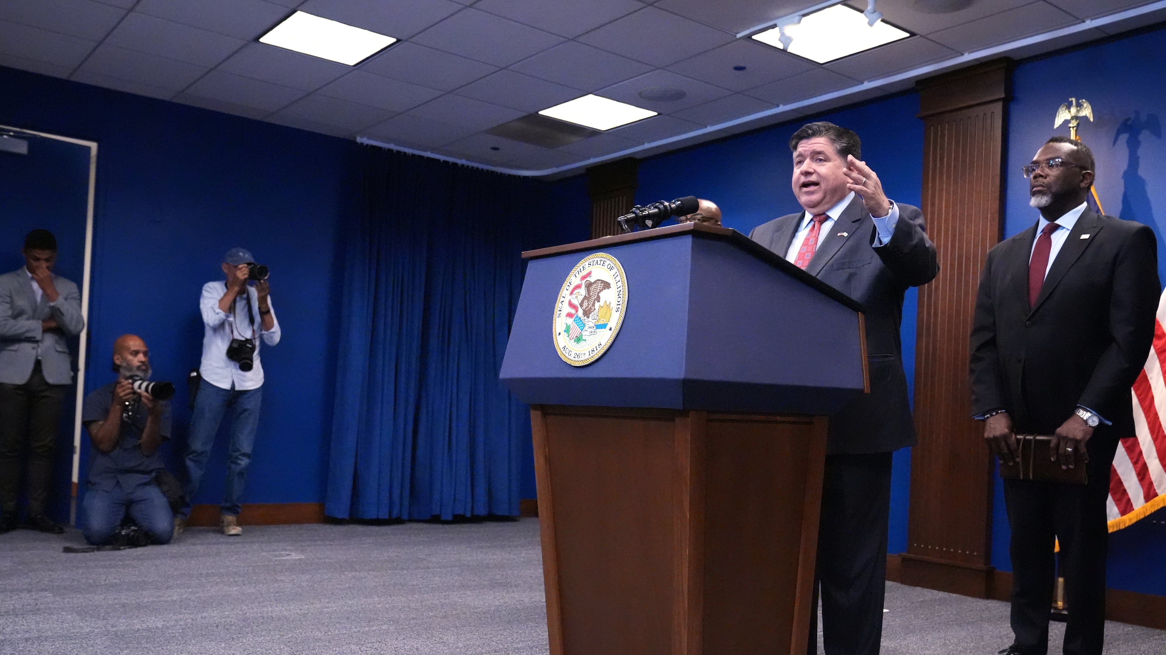 Governor JB Pritzker, second from right, speaks as Chicago Mayor Brandon Johnson, right, listens to him at a news conference in Chicago, Monday, Oct. 6, 2025. (AP Photo/Nam Y. Huh)