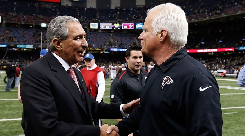 NEW ORLEANS, LA - DECEMBER 21: Head coach Mike Smith of the Atlanta Falcons meets with owner Arthur Blank following a game against the New Orleans Saints at the Mercedes-Benz Superdome on December 21, 2014 in New Orleans, Louisiana. (Photo by Sean Gardner/Getty Images) "Congratulations on beating Saints, Smitty. By the way, I've hired a search firm." (Getty Images)