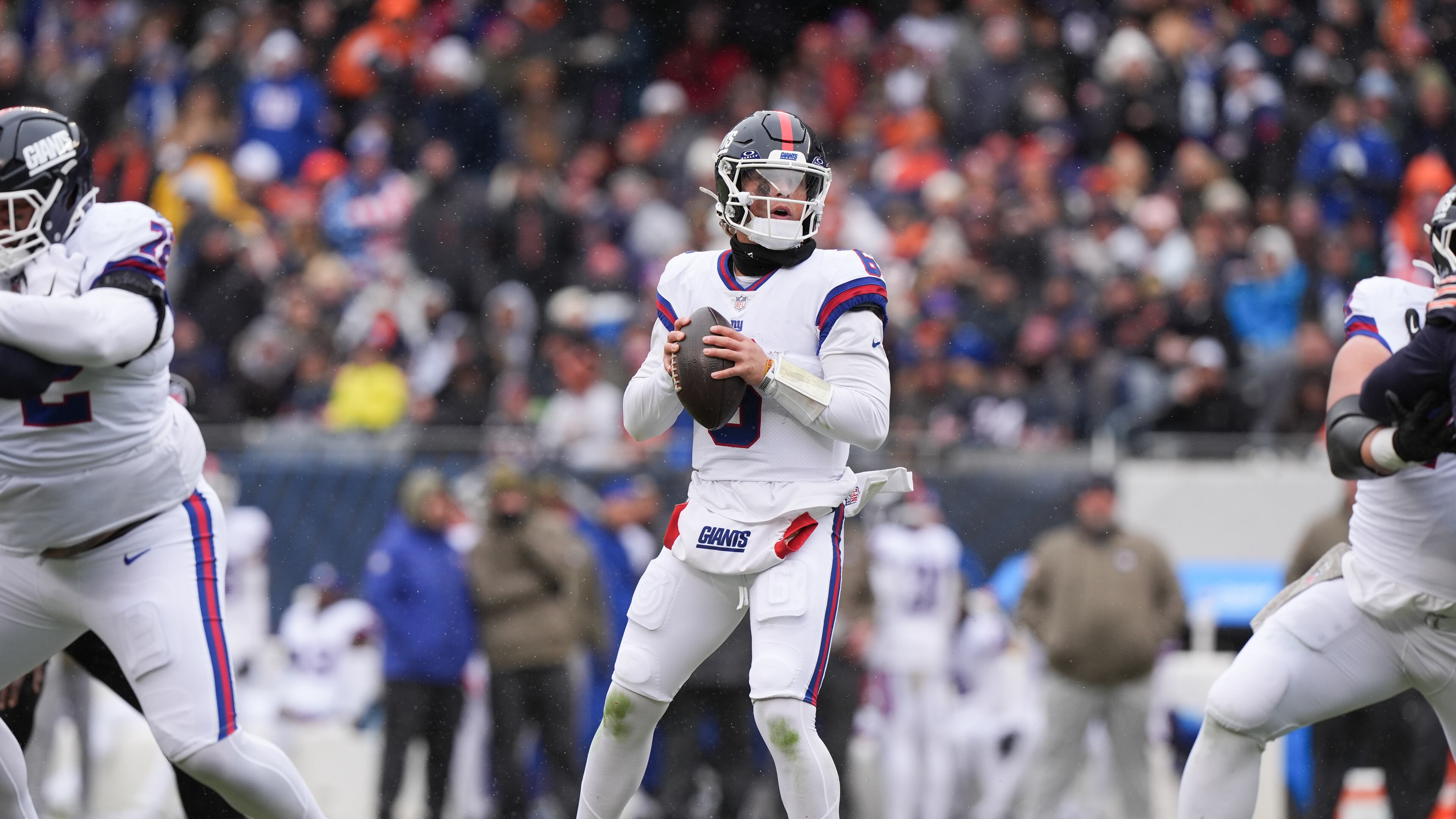 New York Giants quarterback Jaxson Dart, center, looks to throw during the first half of an NFL football game against the Chicago Bears, Sunday, Nov. 9, 2025, in Chicago. (AP Photo/Nam Y. Huh)